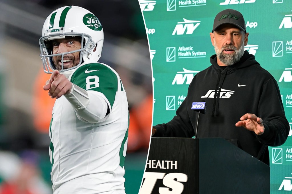 Jets QB Aaron Rodgers points and smiles; interim coach Jeff Ulbrich answers questions.