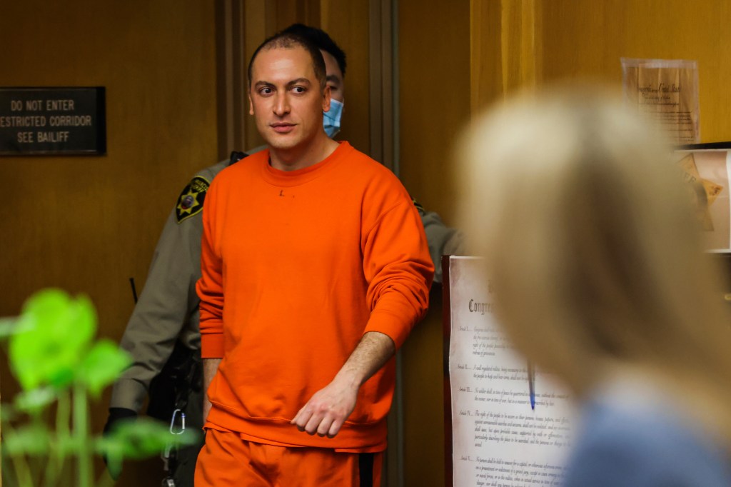 Nima Momeni in orange uniform entering the Hall of Justice courtroom for his arraignment in the case of fatal stabbing of Cash App founder Bob Lee