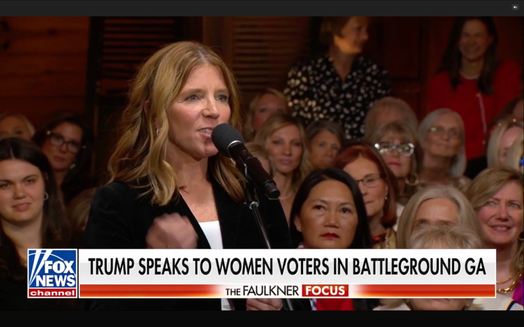 A woman in the audience asks Trump a question.