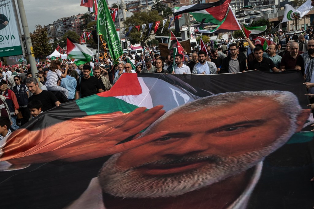 People holding the picture of late Hamas leader Ismail Haniyeh during a protest march in Istanbul, Turkey, in support of Palestinians in Gaza