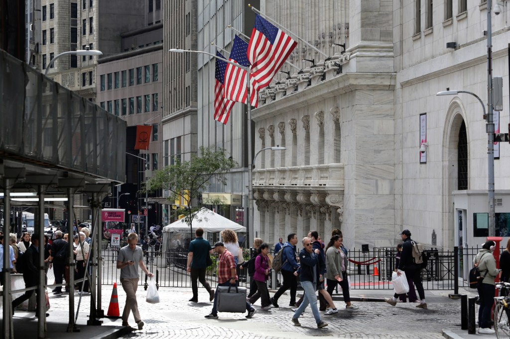 Passersby in front of the New York Stock Exchange on Oct. 1, 2024.