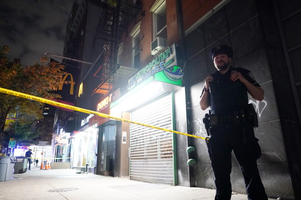 A police officer stands watch over the spot where the attack happened.