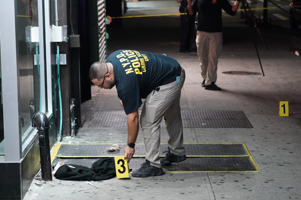 An NYPD officer marks the scene of the attack.