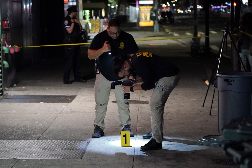 Police at the scene where Paterson and his stepson were assaulted on Friday night.