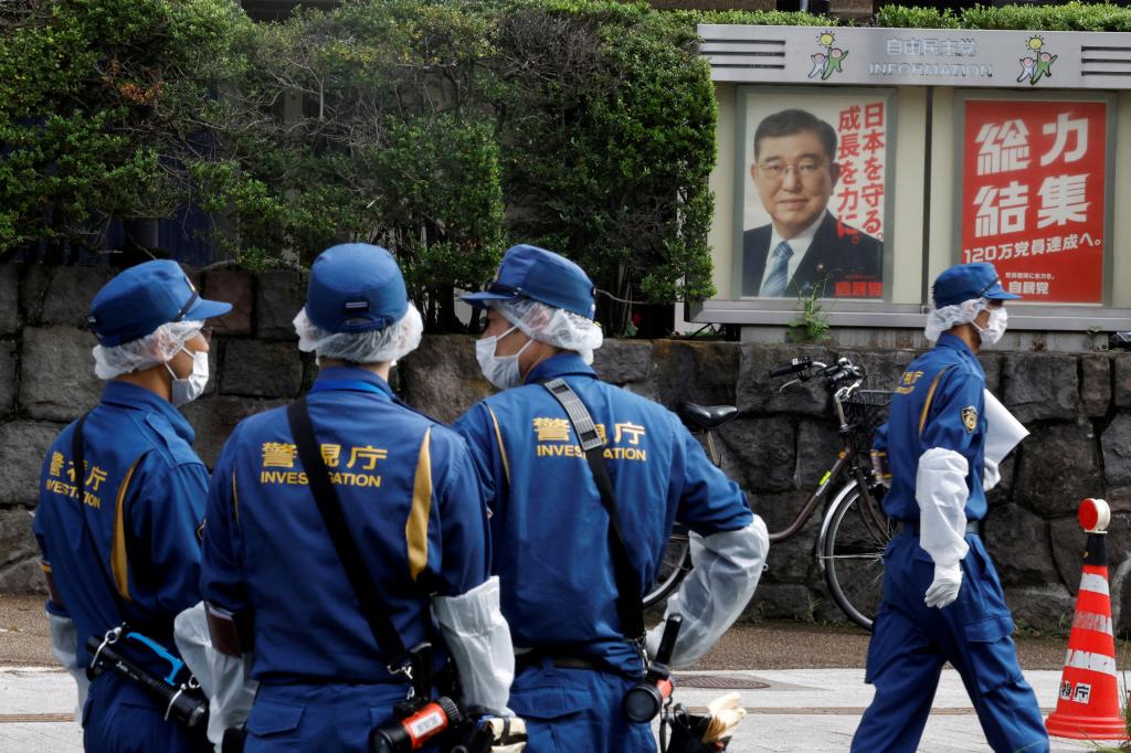 A photo of Japanese Prime Minister Shigeru Ishiba is displayed in the background as officials continue their investigation.