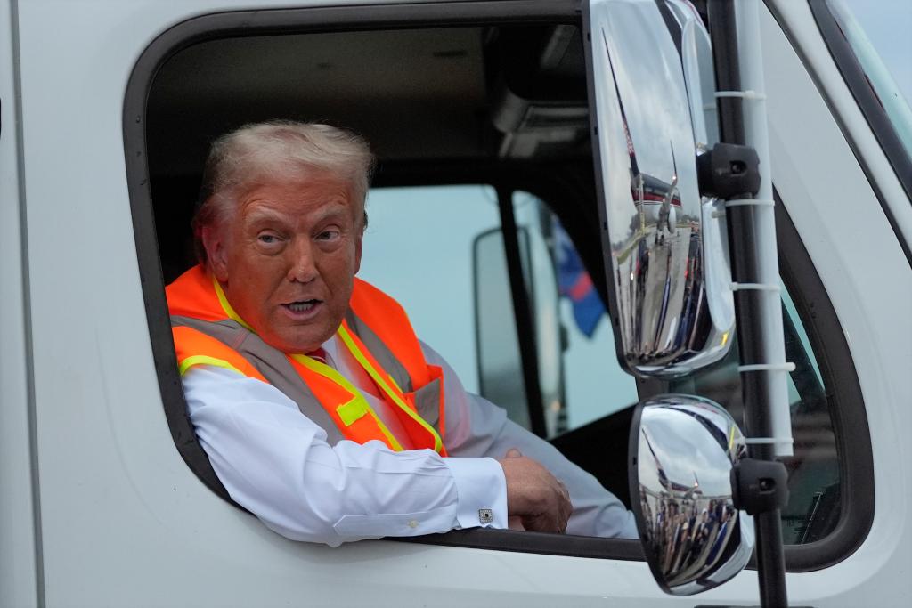 Former President Donald Trump, the Republican presidential nominee, talking to reporters while sitting in a garbage truck in Green Bay, Wisconsin.