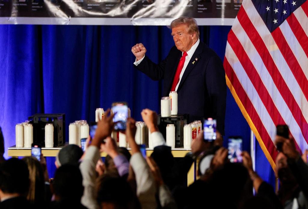 Donald Trump gestures as he attends an event commemorating the one-year anniversary of the October 7 Hamas attacks on Israel, at his golf resort in Doral, Florida, October 7, 2024. 