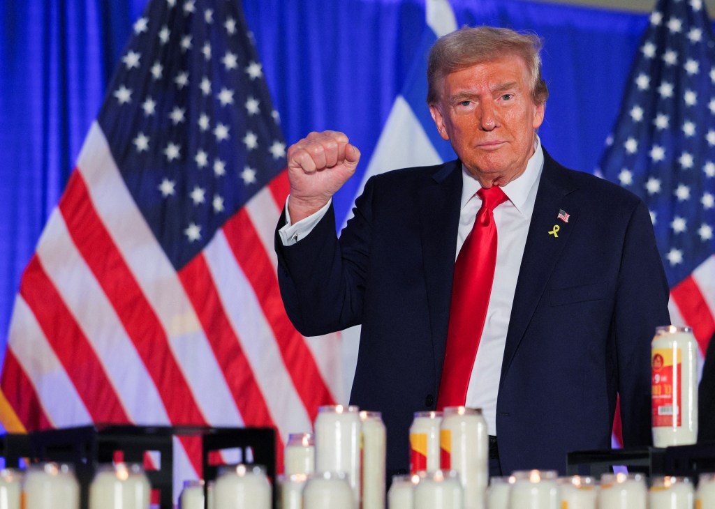 Former President Donald Trump gesturing at an event commemorating the one-year anniversary of the Hamas attacks on Israel at his golf resort in Doral, Florida.