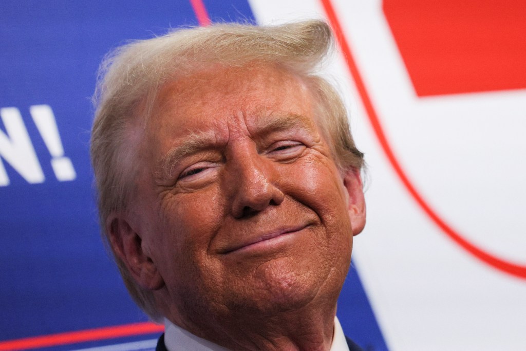 Republican presidential nominee and former U.S. President Donald Trump looks on as he visits a campaign office in Hamtramck, Michigan, U.S. October 18, 2024.