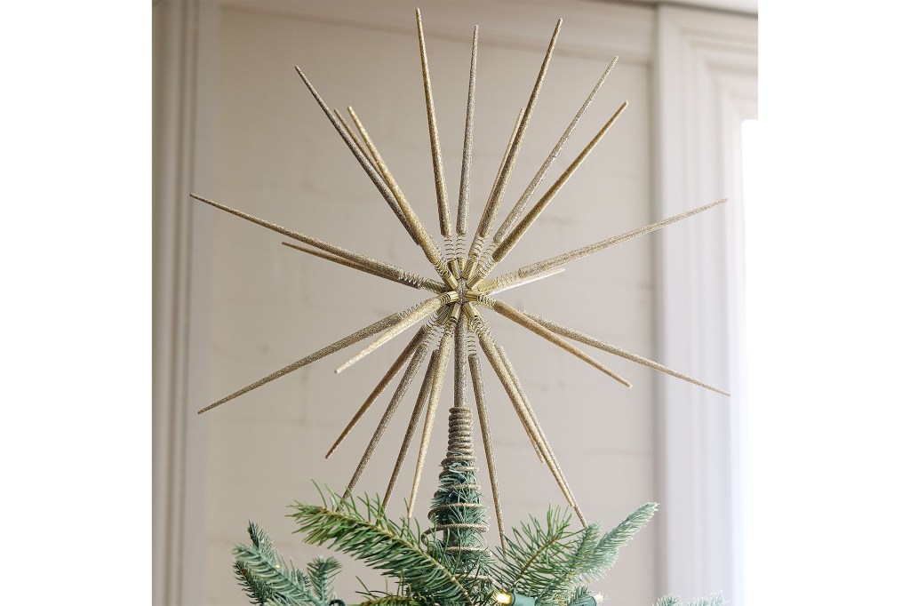 A gold star topper on a retro style Christmas tree