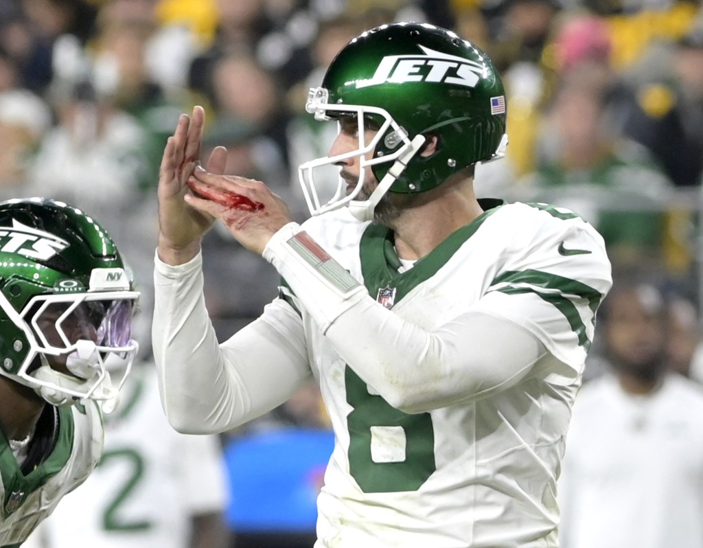 Aaron Rodgers' hand bleeds as he calls timeout. 