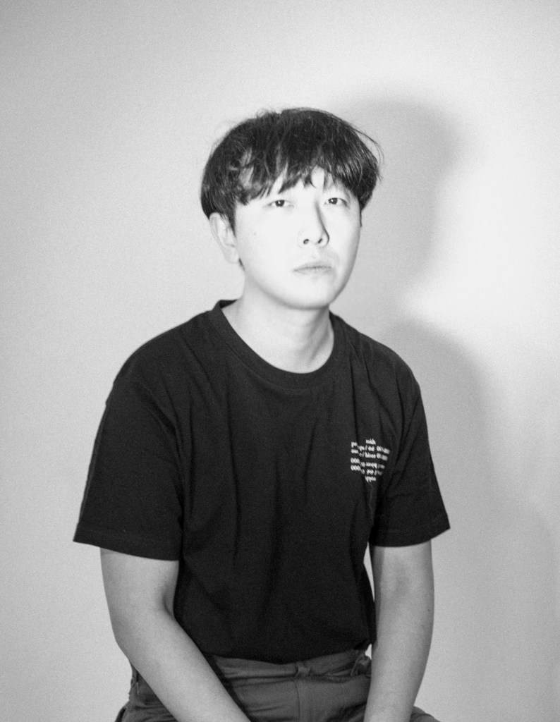 Headshot of designer Rok Hwang, wearing a black shirt, for the GU x Rokh Collab Collection