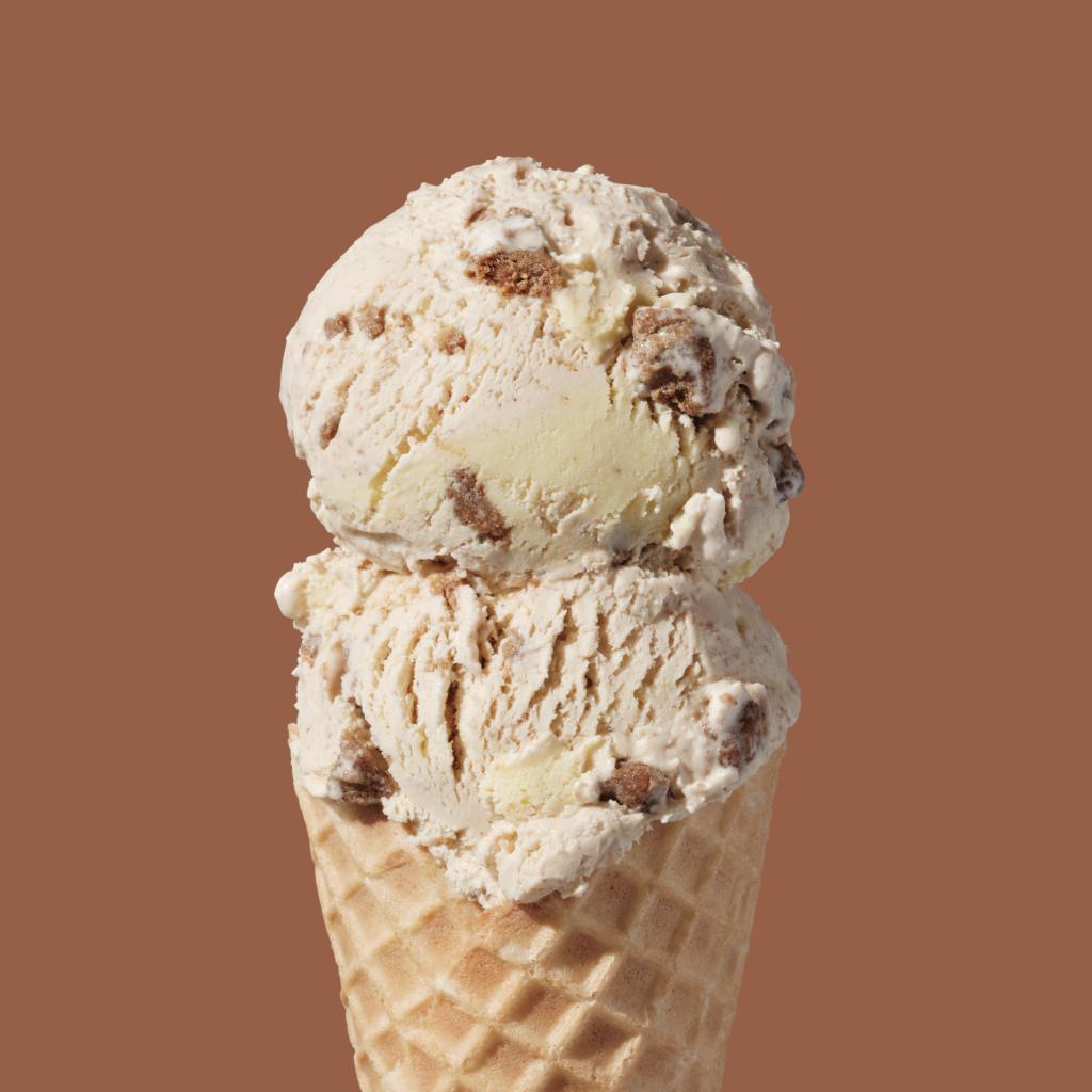 Close up two scoops of pastrami on rye ice cream in a cone at Salt & Straw. 