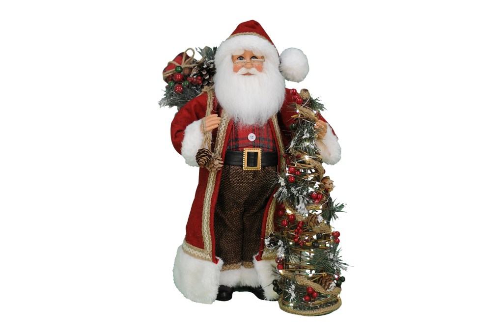 Santa Claus figurine standing next to a Christmas tree