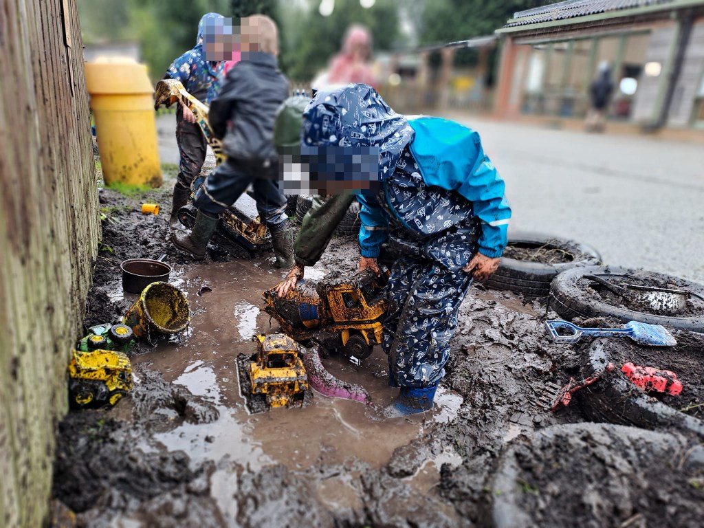 A group of children playing in the newly introduced muddy play area at Holsworthy Primary School in North Devon