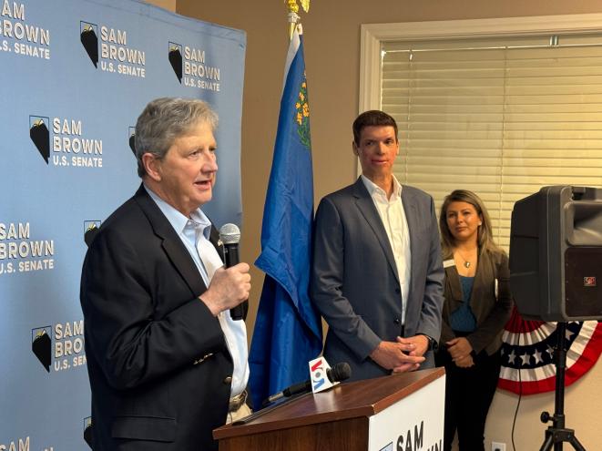 Sen. John Kennedy standing at a podium with microphones, praising Nevada GOP U.S. Senate candidate Sam Brown during a Las Vegas event