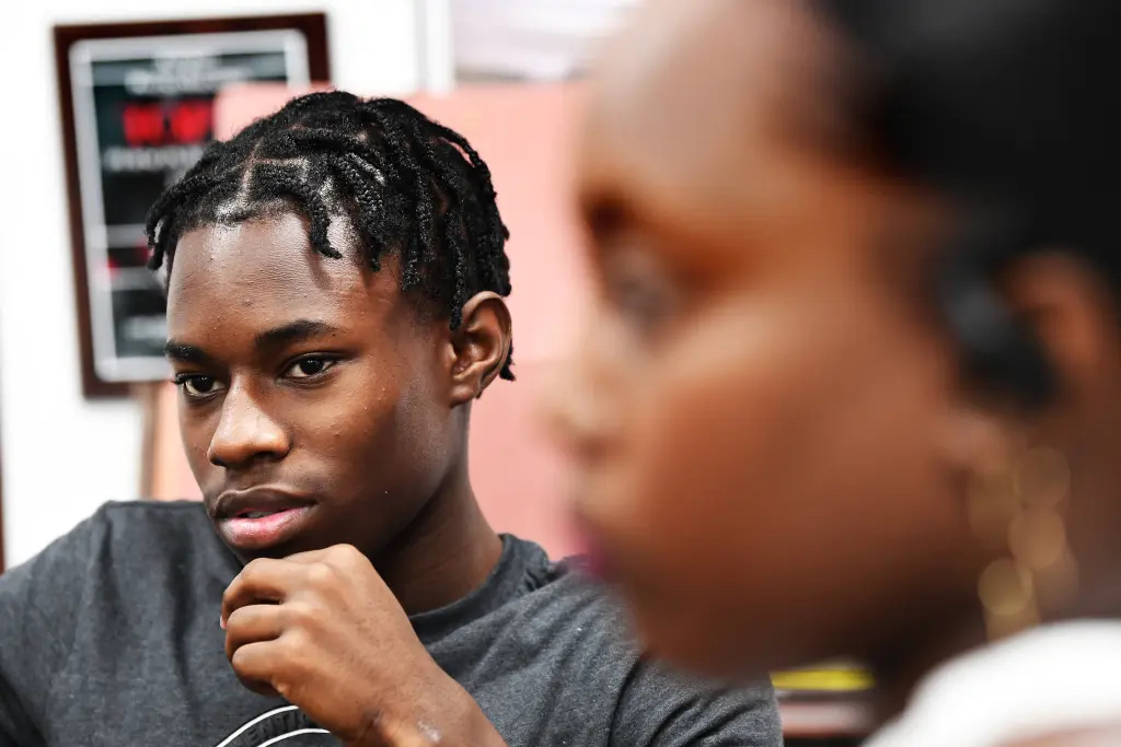 Shayson Willock, 15, standing with his mother, Deslyn, after surviving a harsh incident at school which required him to have staples in his skull.