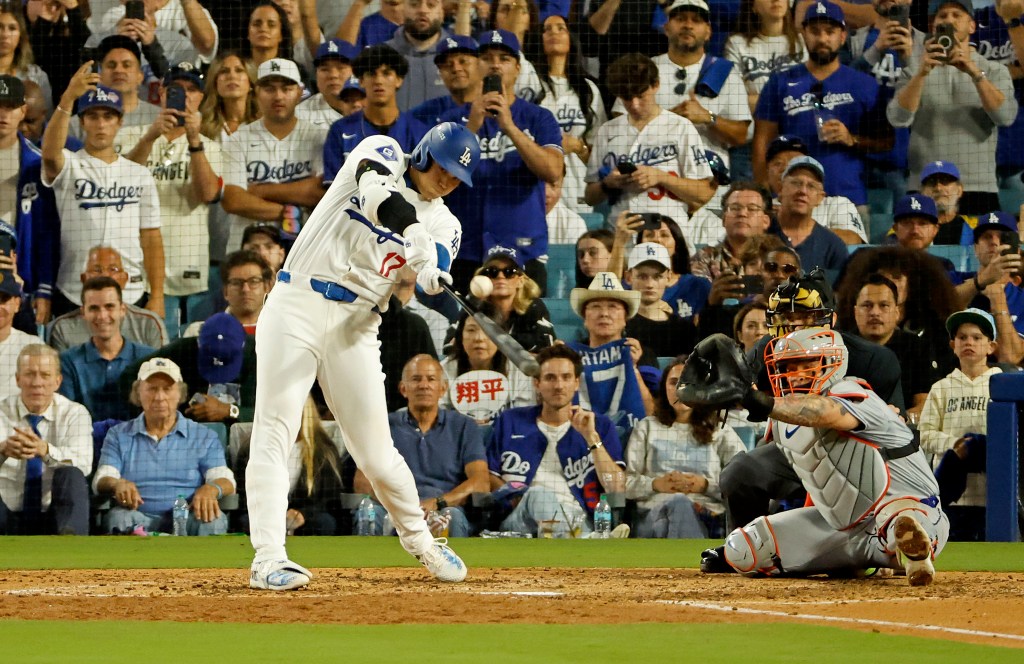 Shohei Ohtani #17 of the Los Angeles Dodgers hits an RBI single during the NLCS.