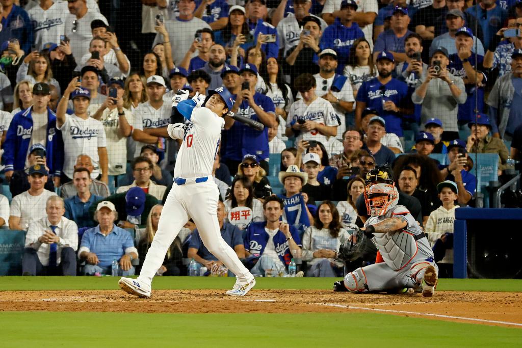 Shohei Ohtani #17 of the Los Angeles Dodgers hitting an RBI single during the 6th inning of NLCS game 6 against New York Mets at Dodger Stadium