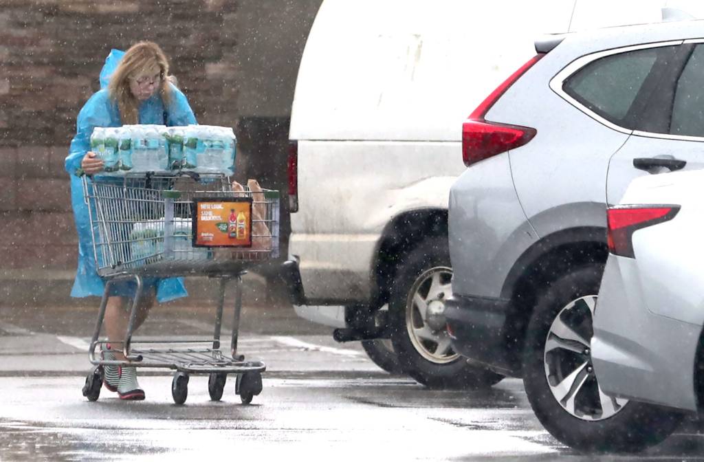 A shopper stocking up on bottled water in Daytona Beach in preparation for Milton.