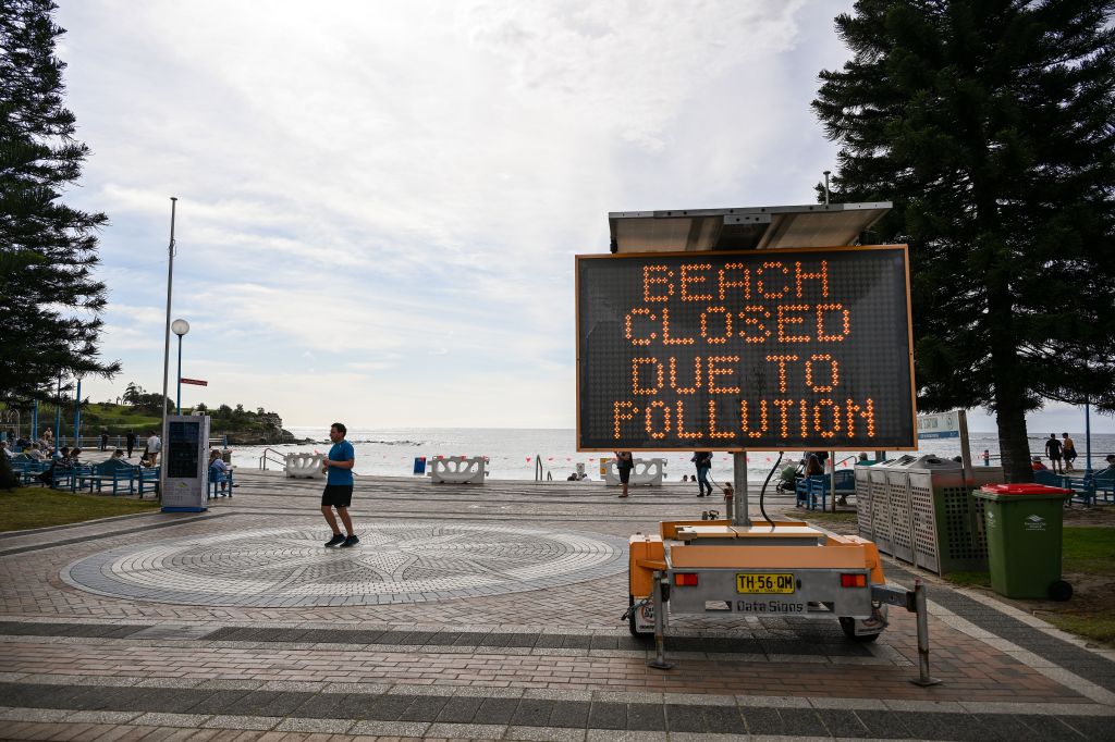 A sign warns of a Beach closure as unkown debris washed up on Coogee Beach.