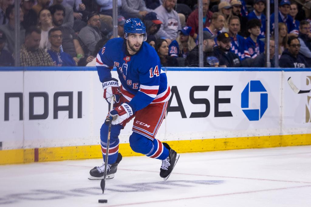 Rangers defenseman Connor Mackey (14) skates with the puck