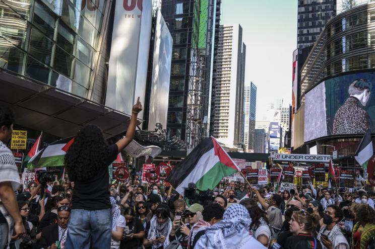 A speaker from the Palestinian Youth Movement addresses the crowds at Washington Square Park after the march against the year long humanitarian crisis brought on by the siege of the Gaza Strip by Israel.