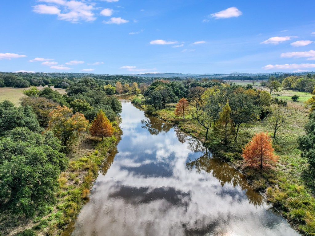 Known as 3 Creeks Ranch, the estate features three historic homes, six ponds, and over 2.5 miles of creek frontage in Fredericksburg's scenic wine region. 