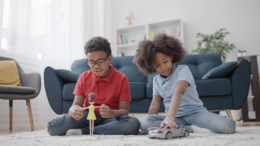 two kids playing with toys.