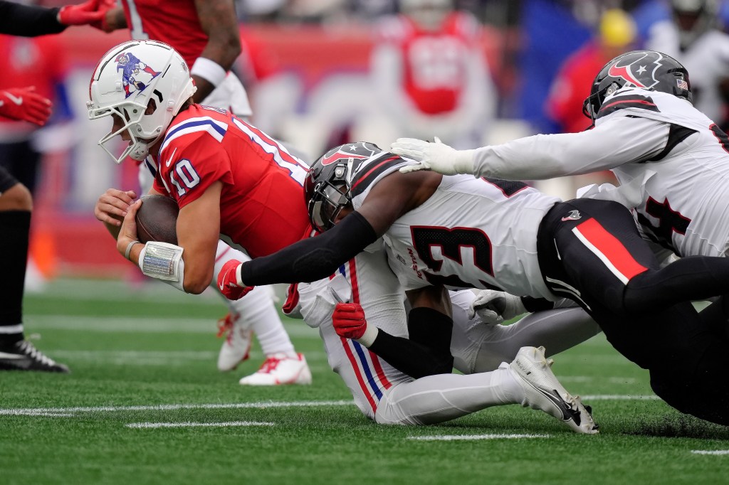 Houston Texans safety Eric Murray (23) tackles New England Patriots quarterback Drake Maye (10) on a carry during the first half of an NFL football game, Sunday, Oct. 13, 2024, in Foxborough, Mass. 