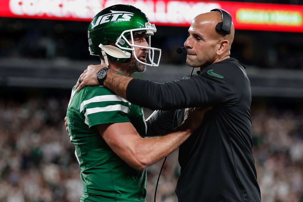 Jets quarterback Aaron Rodgers (l.) talks with Robert Saleh (r.) during a game against the Patriots on Sept. 19, 2024.