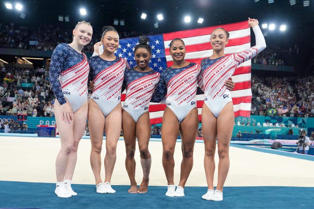 Team USA from left to right, Jade Carey, Suni Lee, Simone Biles, Jordan Chiles and Hezly Rivera celebrate after winning the gold medal during the women's artistic gymnastics team finals round at Bercy Arena at the 2024 Summer Olympics, Tuesday, July 30, 2024, in Paris, France.