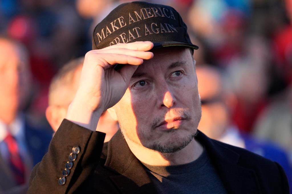 Elon Musk in black MAGA hat during Trump rally on Oct. 5, 2024.