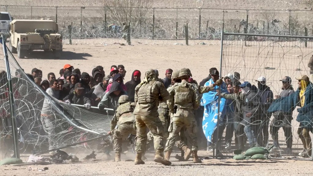 Texas National Guard pushed back a large group of almost 60 migrants who crossed the border illegally and breached the concertina wire barriers set up along the US side of the Rio Grande river.