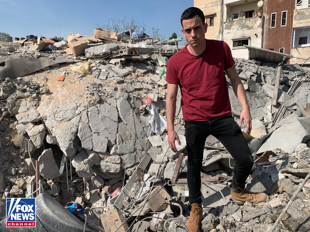 Black Saturday - Trey Yingst standing at a crater in Gaza after an Israeli airstrike in 2018.