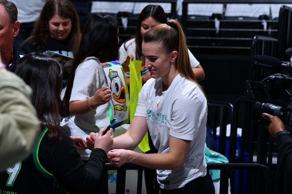 Sabrina Ionescu #20 of the New York Liberty signs autographs