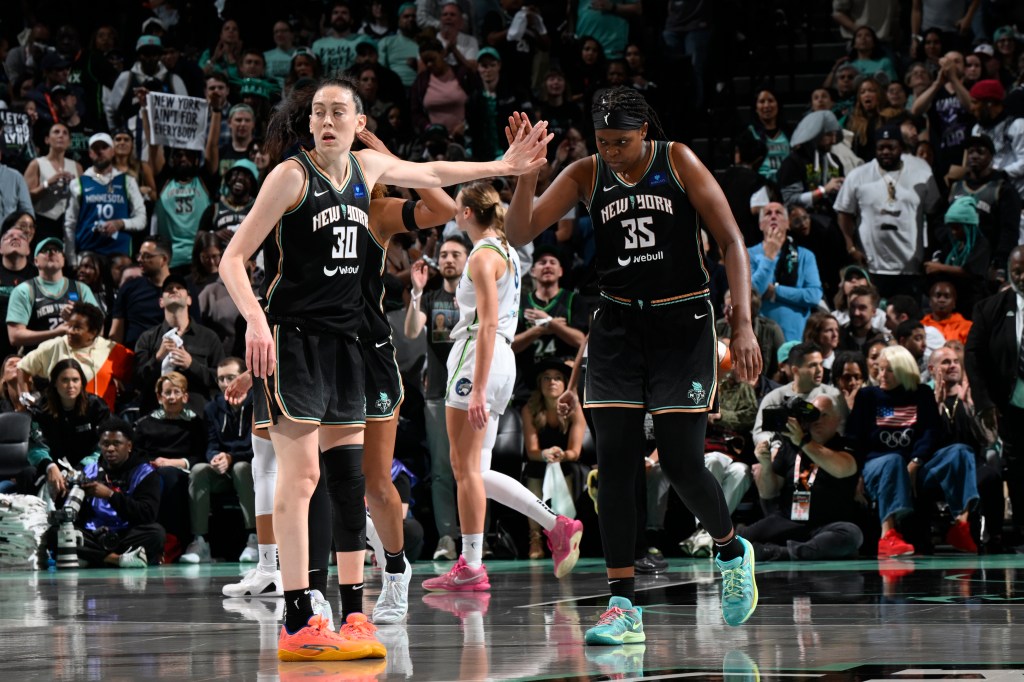 Breanna Stewart #30 and Jonquel Jones #35 of the New York Liberty high five during the game against the Minnesota Lynx during Game 5 of the WNBA Finals on October 20, 2024