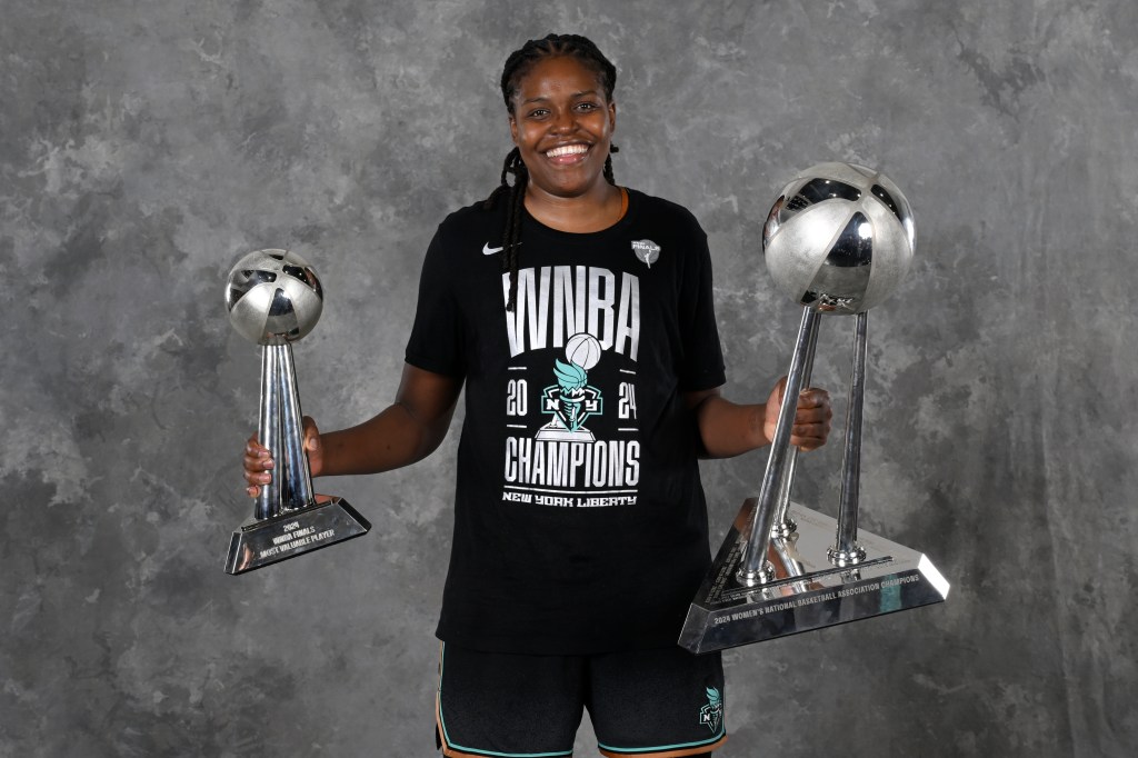 Jonquel Jones #35 of the New York Liberty poses for a portrait with the 2024 WNBA Championship trophy and 2024 WNBA Finals MVP Award.