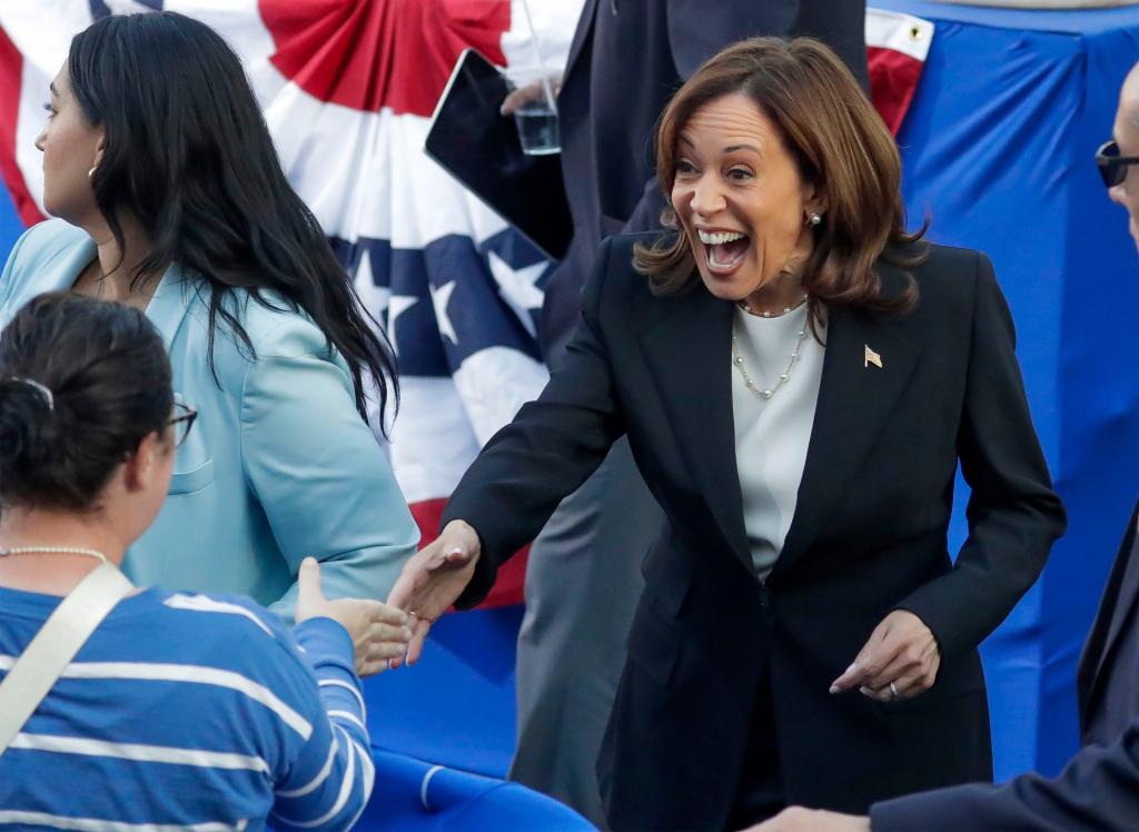 Kamala Harris shaking hands with a supporter.