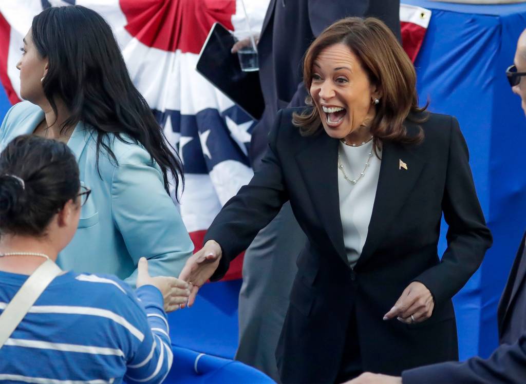 Kamala Harris shaking hands with a supporter.