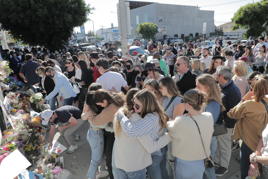 Group of people hugging at a vigil for UCLA student Brianna Kupfer in Los Angeles, California