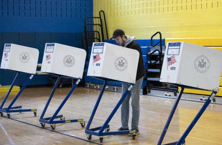 A voter casting his ballot in a Manhattan polling station during the 2024 New York presidential primary