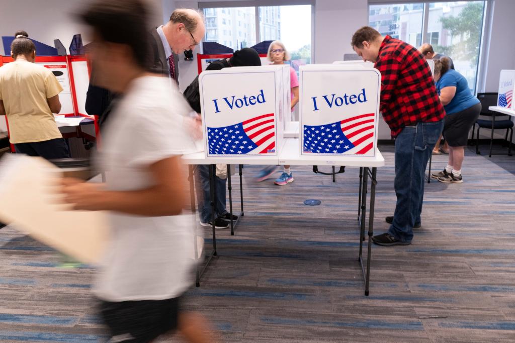 Voters work on their ballot at a polling station at the Elena Bozeman Government Center in Arlington, Virginia, on September 20, 2024.