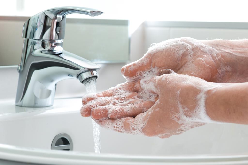 Washing of hands with soap under running water