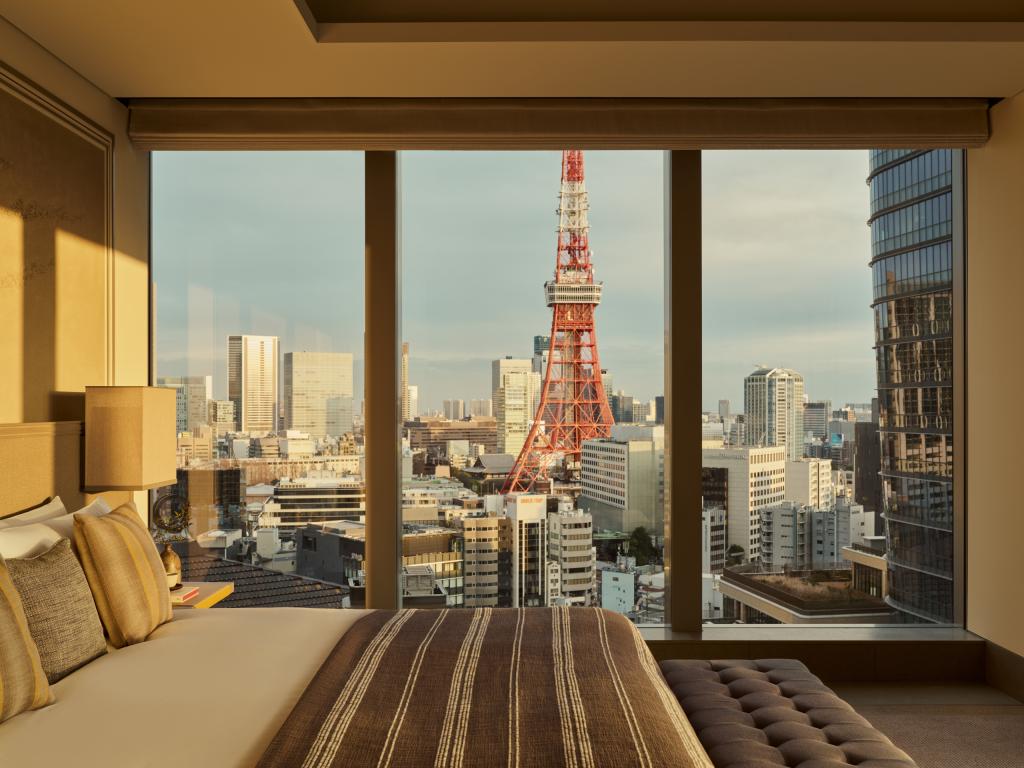 A bedroom in Janu Suite, Tokyo with a large window overlooking the city