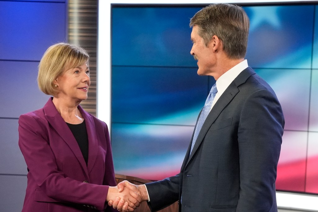 Wisconsin Senate candidates Republican Eric Hovde and Democratic U.S. Sen. Tammy Baldwin shaking hands before a televised debate in Madison, Wisconsin, 2024