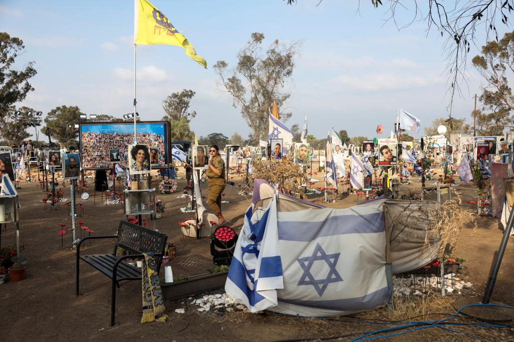 A woman walks, as people visit the site of the Nova festival, where partygoers were killed and kidnapped during the October 7 attack