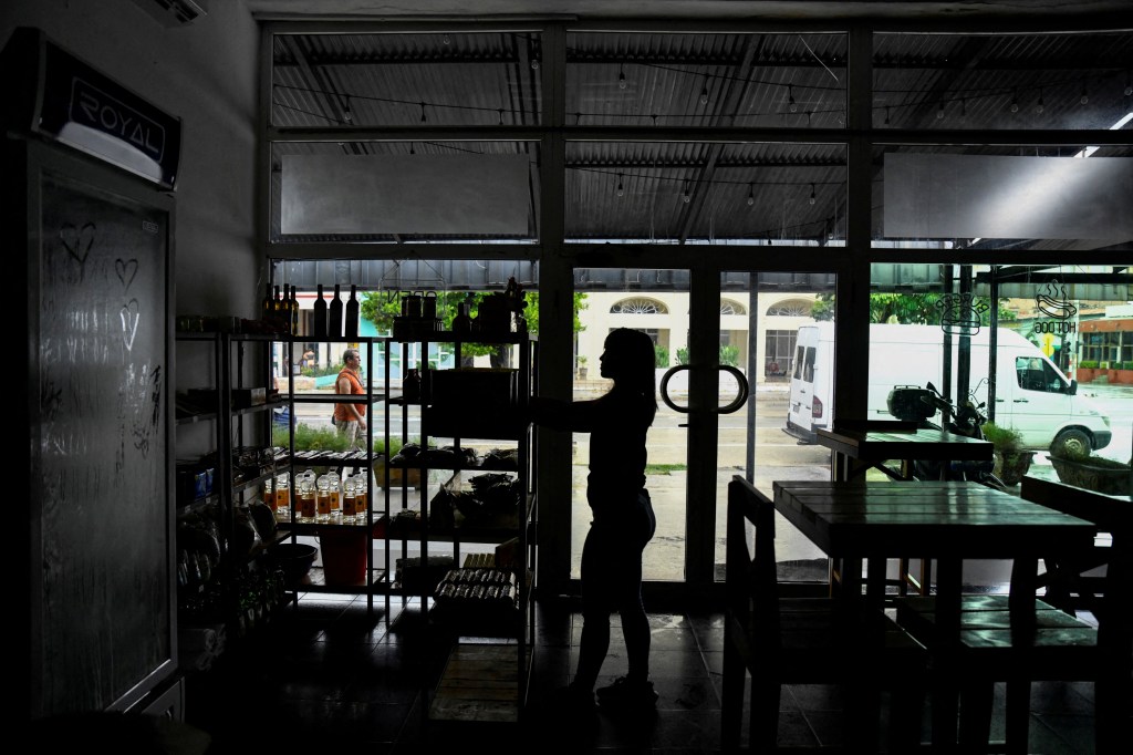 A woman works in a restaurant during a blackout in Havana, Cuba, October 17, 2024.