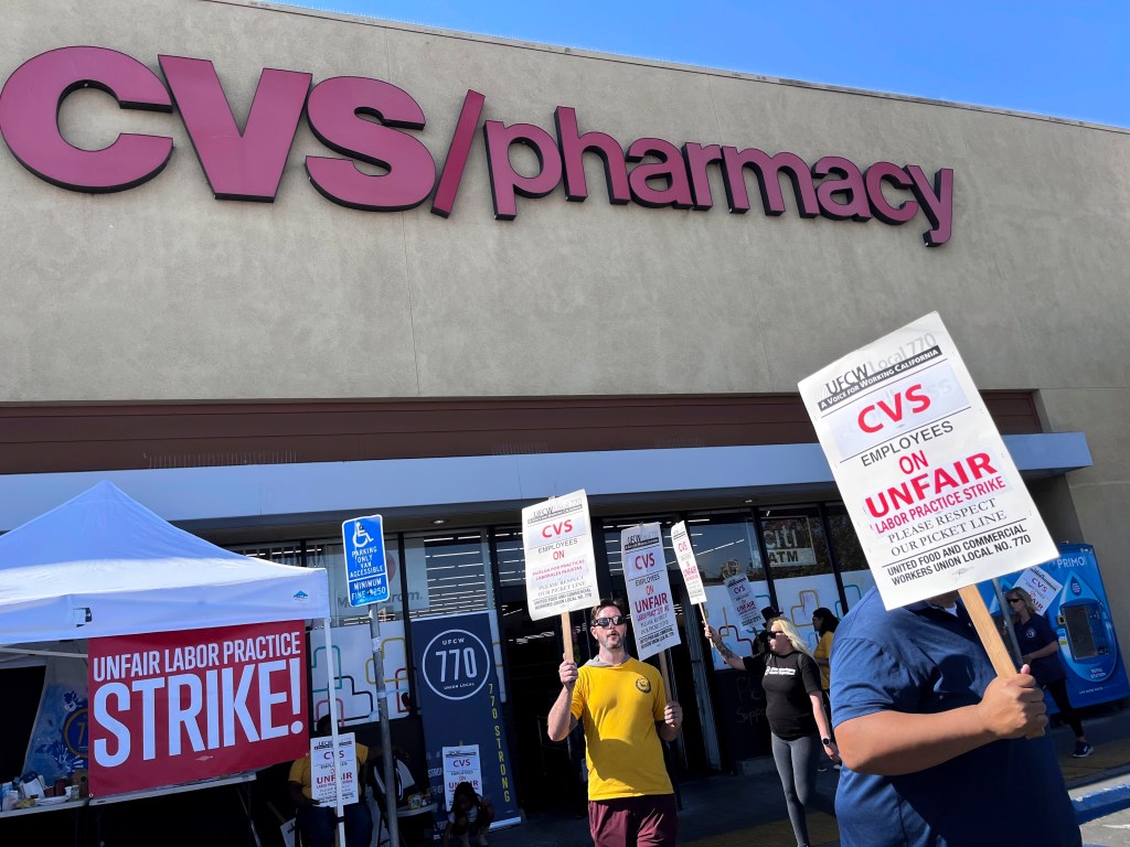 Striking workers picket in front of a CVS pharmacy in Los Angeles on Saturday.