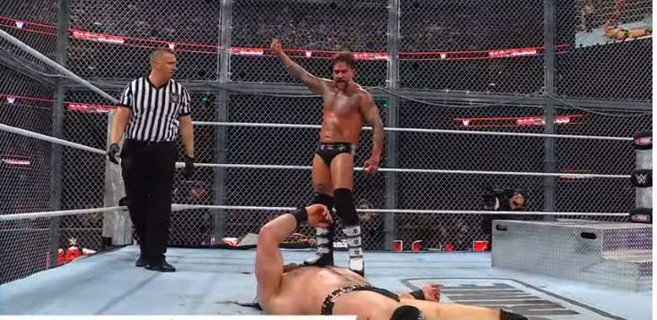 CM Punk threatens to hit Drew McIntyre with a wrench.